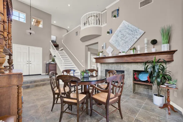 a view of a dining room with furniture a chandelier and wooden floor