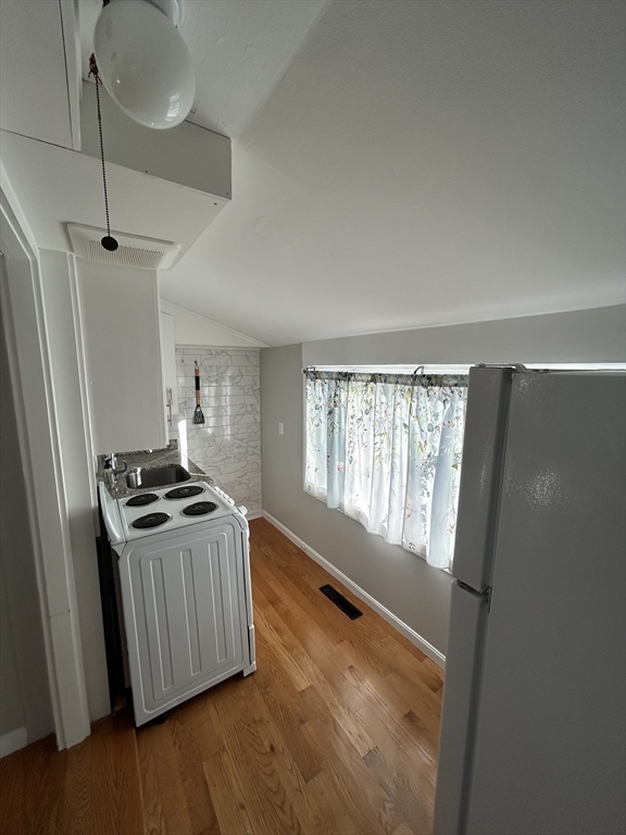 41 Union Street, Unit R Rockland, MA 02370 - Photo 8 of 9 a kitchen with granite countertop a stove and a refrigerator