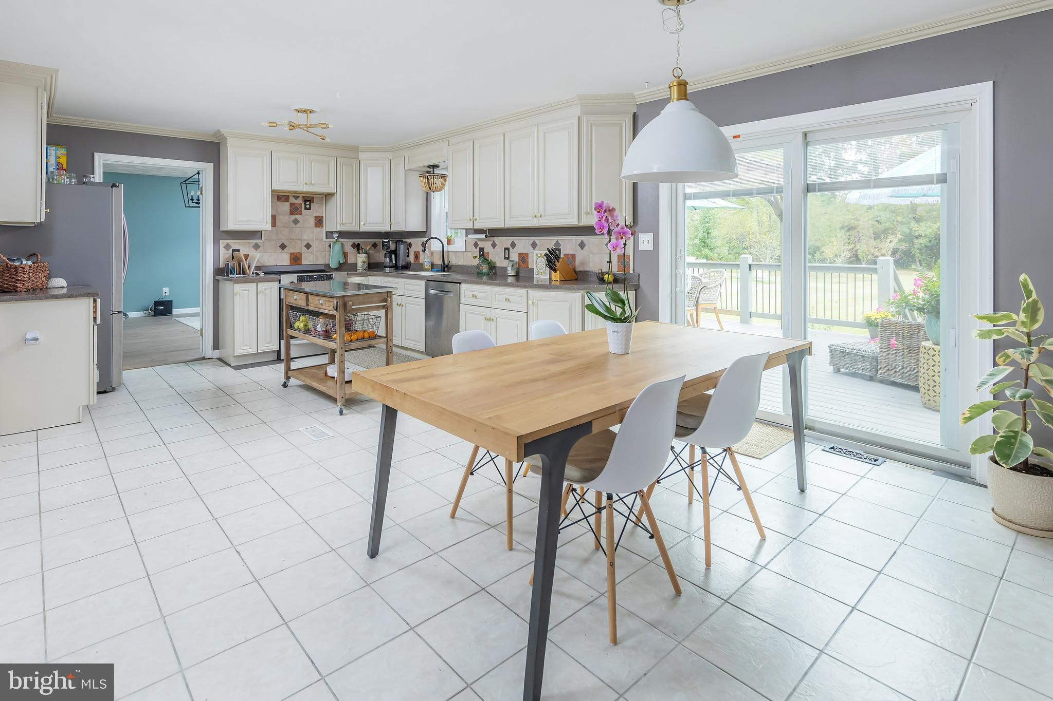 141 West Tomlin Station Road Mickleton, NJ 08056 - Photo 12 of 33 a kitchen with stainless steel appliances a table and chairs in it
