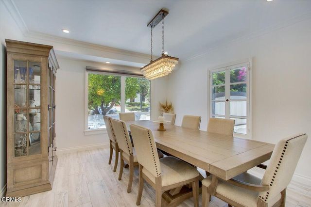a kitchen with a sink window and cabinets