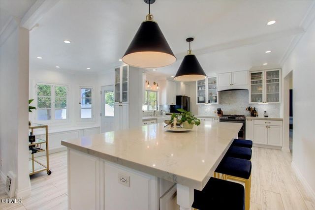 a spacious bedroom with a bed and a dresser