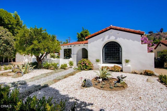 a view of a patio with table and chairs and potted plants