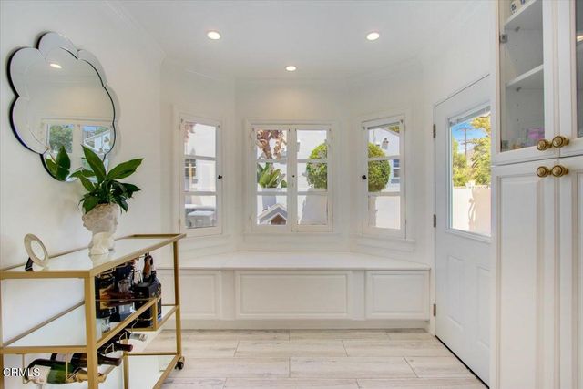 a view of a bedroom with wooden floor and a sink