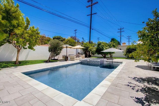 an aerial view of multiple houses with a yard