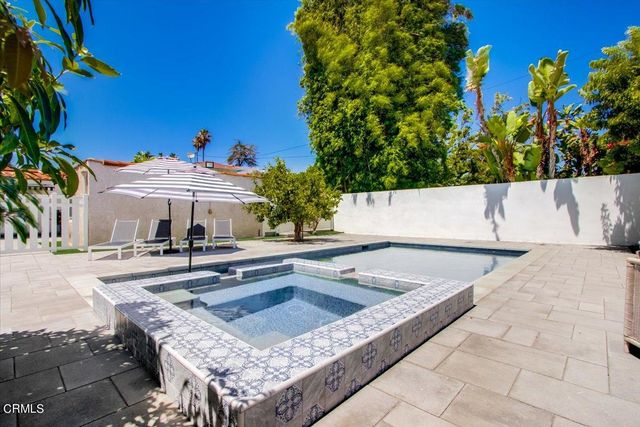 an aerial view of a house with garden space and street view