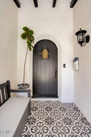 a living room with furniture a fireplace and a floor to ceiling window
