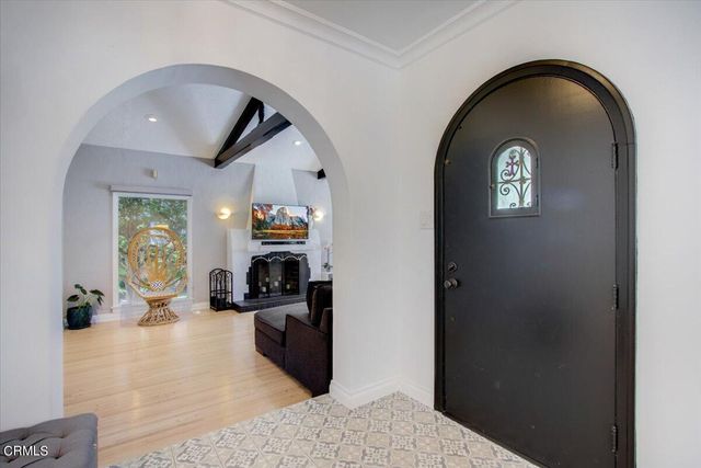 a living room with furniture a flat screen tv and a large window