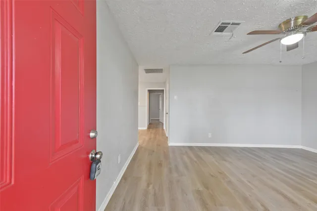 a view of a room with wooden floor and staircase