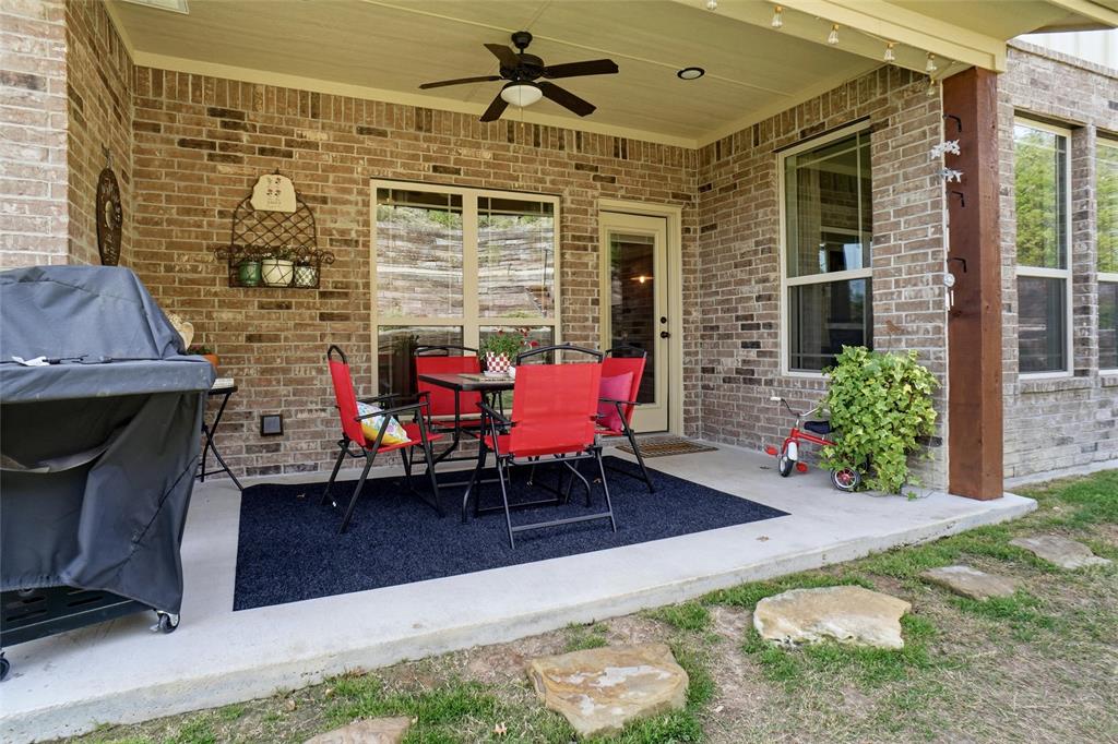 1024 Tex Lane Springtown, TX 76082 - Photo 36 of 40 a brick building with a bench in front of it