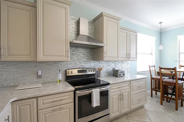 a kitchen with stainless steel appliances granite countertop a refrigerator and a stove top oven