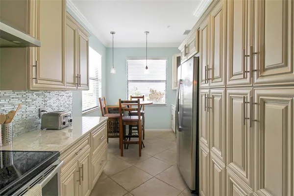 a view of a room with a table and chairs