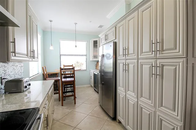 a kitchen with stainless steel appliances granite countertop a sink and a granite counter tops