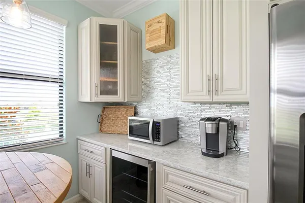 a dining room with furniture a chandelier and a rug
