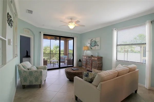 a living room with furniture and a chandelier