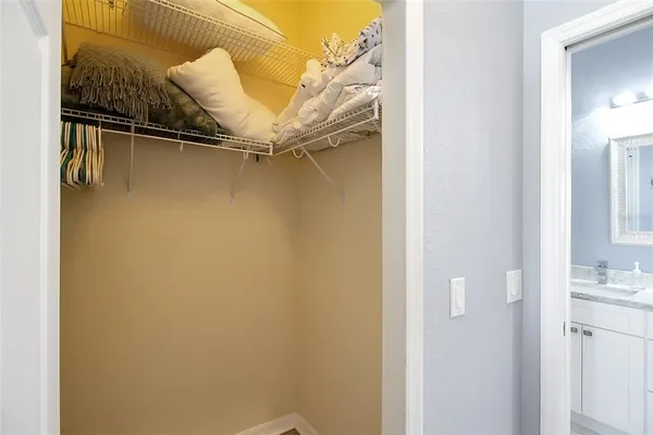 a bathroom with a granite countertop toilet sink and mirror