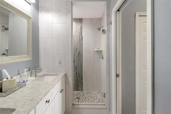 a living room with furniture a ceiling fan and a window