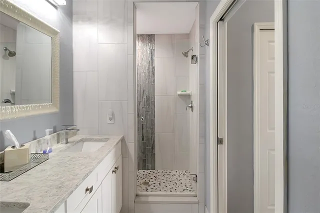 a living room with furniture a ceiling fan and a window