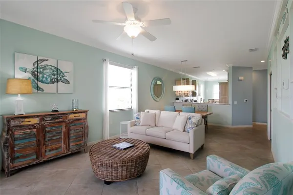 a view of a hallway with wooden floor and a living room