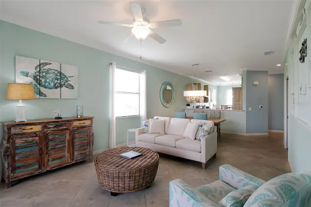 a view of a hallway with wooden floor and a living room