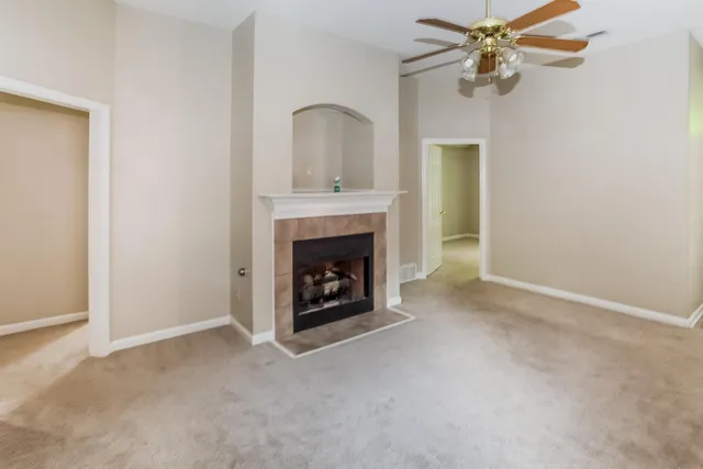a view of an empty room with a fireplace