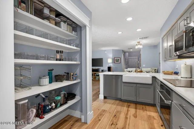 a front view of a house with a garden and parking