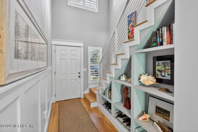 a living room with furniture kitchen view and a large window