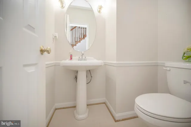 a bathroom with a sink a toilet and mirror