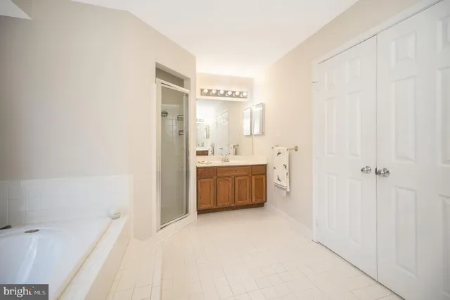 a bathroom with a tub sink and a mirror