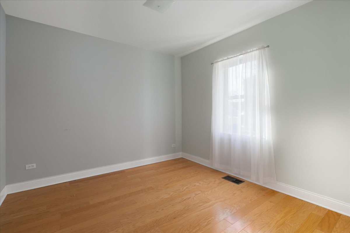 4055 North Spaulding Avenue, Unit 1 Chicago, IL 60618 - Photo 9 of 13 an empty room with a window
