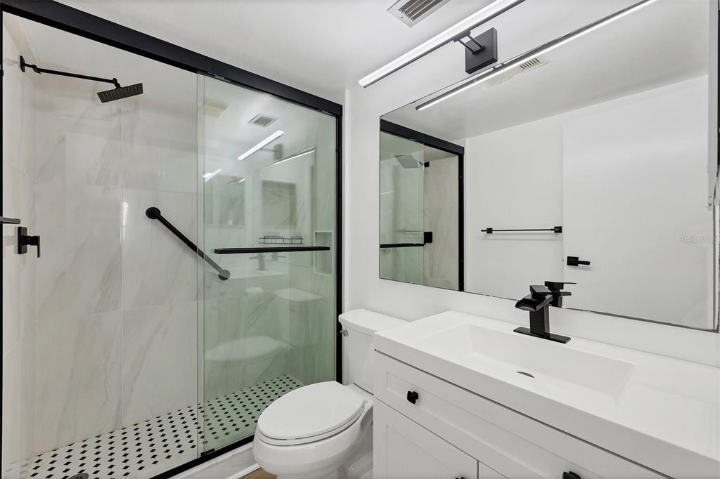 3231 South Beneva Road, Unit 103 Sarasota, FL 34232 - Photo 15 of 31 a bathroom with a sink a toilet and a shower