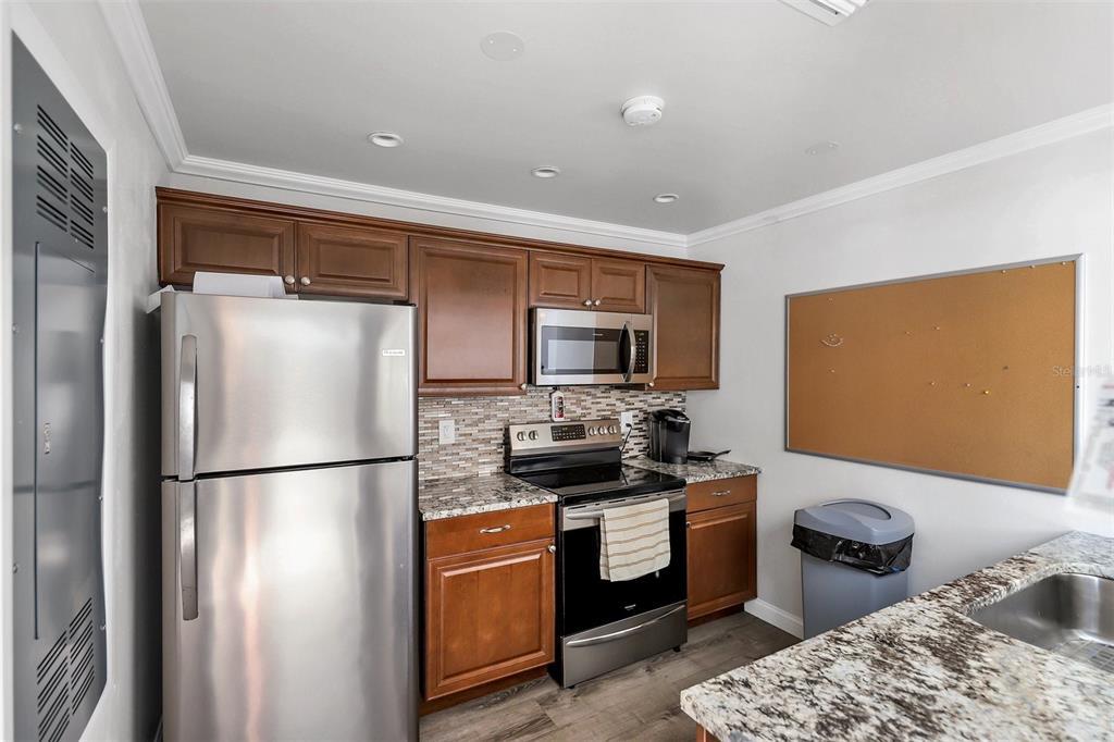 3231 South Beneva Road, Unit 103 Sarasota, FL 34232 - Photo 25 of 31 a kitchen with stainless steel appliances granite countertop a refrigerator a sink and a stove