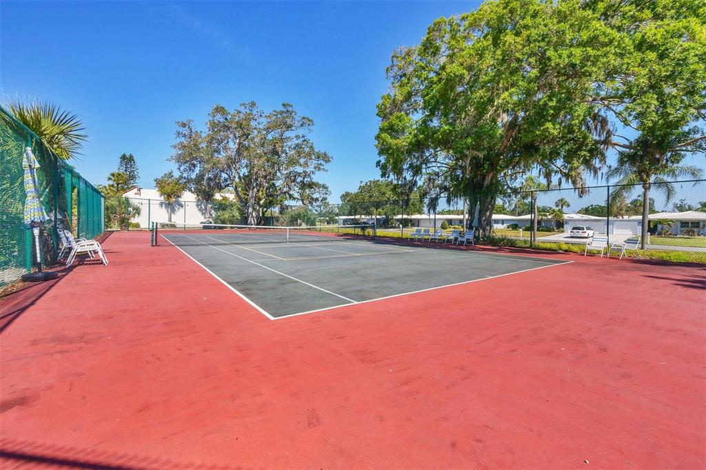 3231 South Beneva Road, Unit 103 Sarasota, FL 34232 - Photo 28 of 31 a view of outdoor space with swimming pool and trees