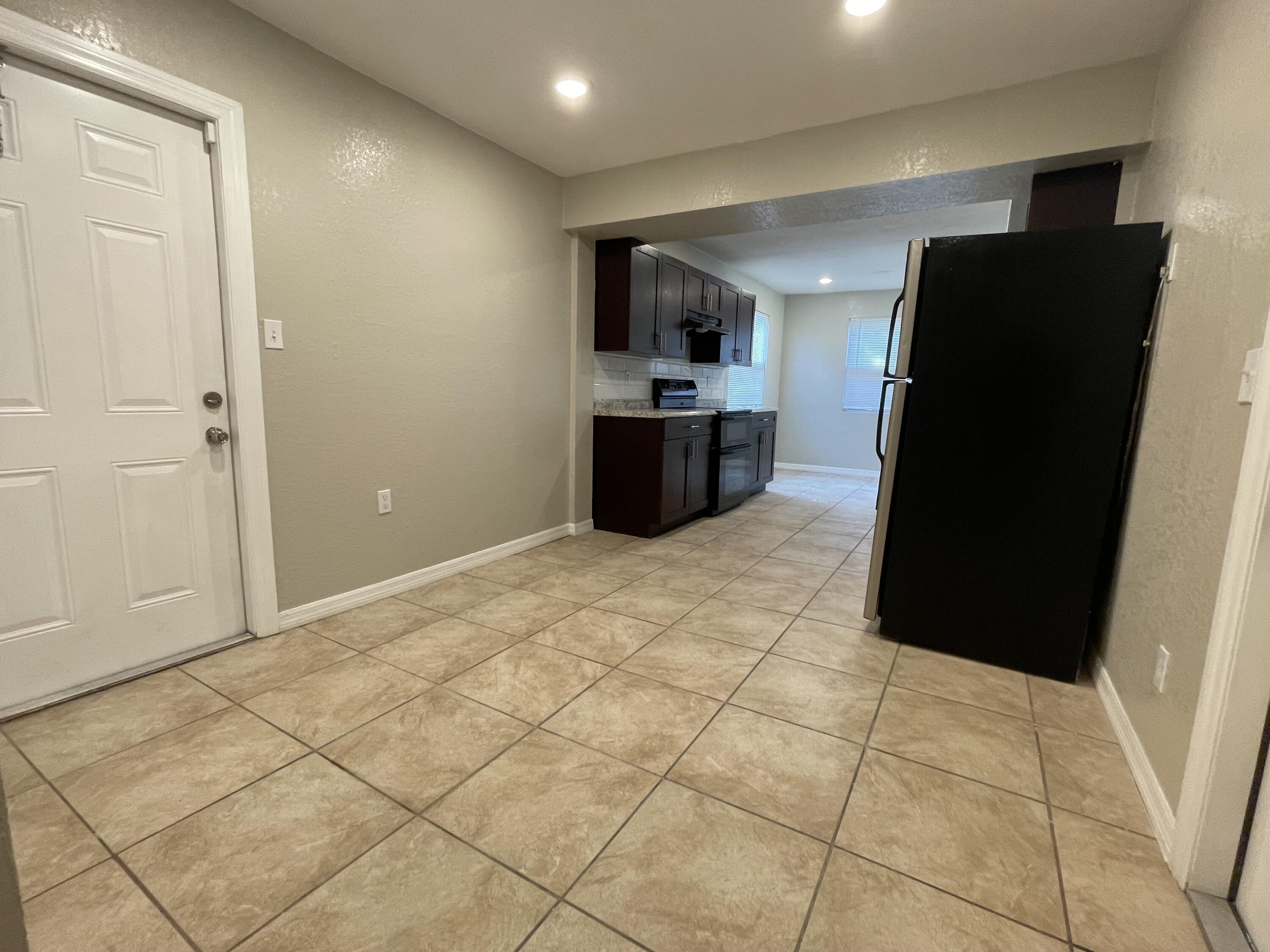 2880 Harson Way Fort Pierce, FL 34946 - Photo 10 of 40 a kitchen with granite countertop a refrigerator and a stove top oven