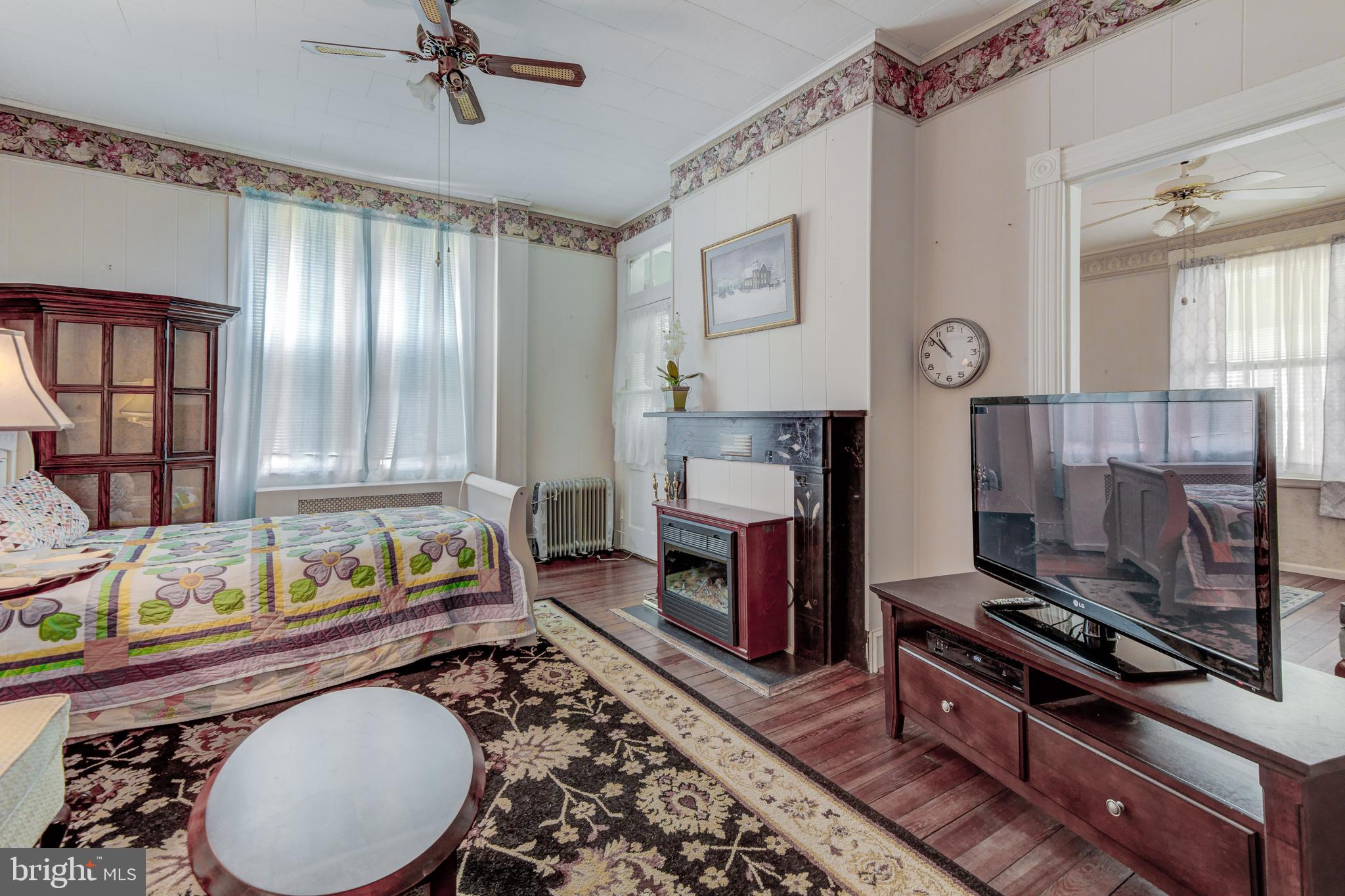 4504 Ridge Avenue Baltimore, MD 21227 - Photo 7 of 31 a living room with furniture a fireplace and a window
