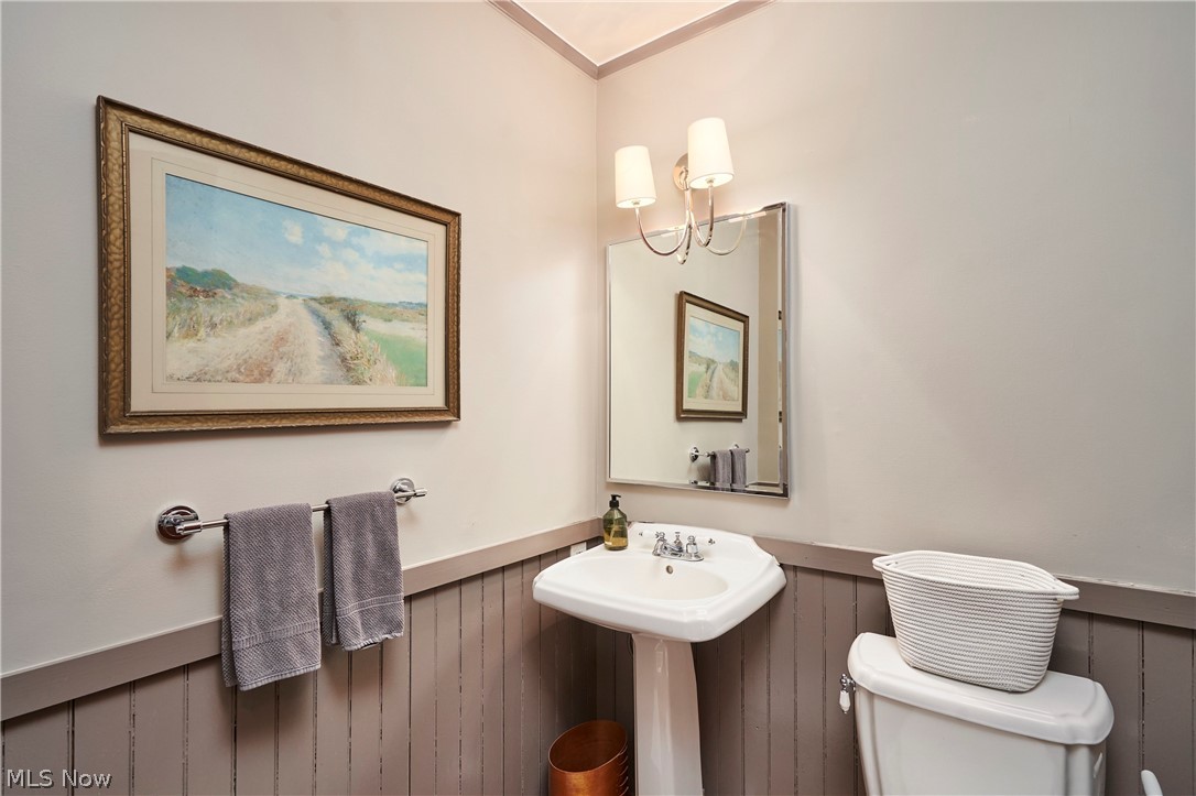 5046 Alger Road Richfield, OH 44286 - Photo 21 of 49 Pedestal sink with chrome faucet, complemented by a rectangular mirror and two-light vanity sconce