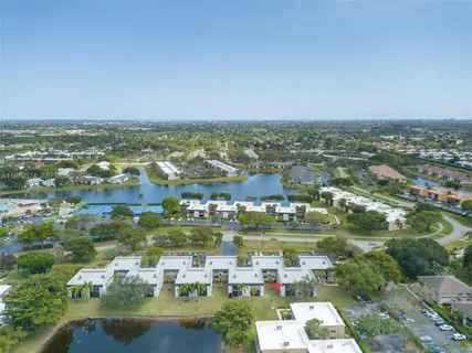 an aerial view of residential houses with city view