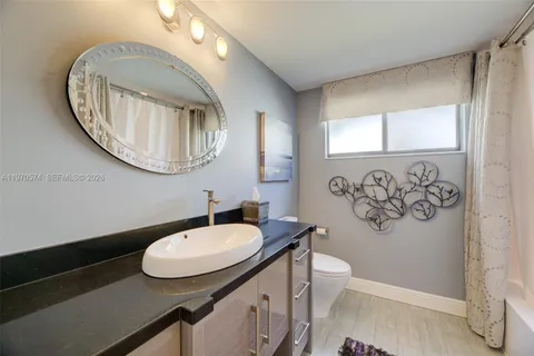 a bathroom with a toilet a sink and a mirror