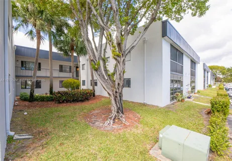 a view of a house with backyard porch and sitting area