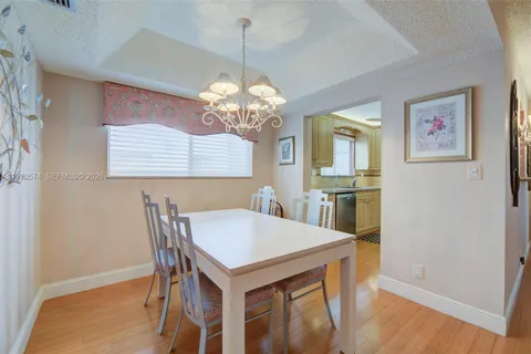 a view of a dining room with furniture and window