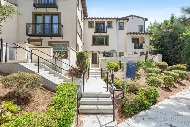 a front view of a residential apartment building with a yard