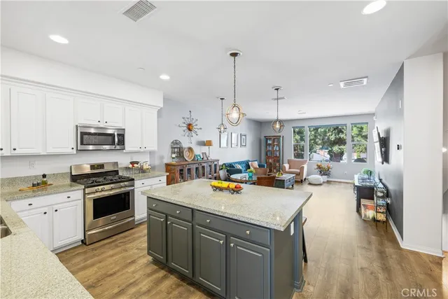 a kitchen that has a lot of cabinets a sink and appliances in it