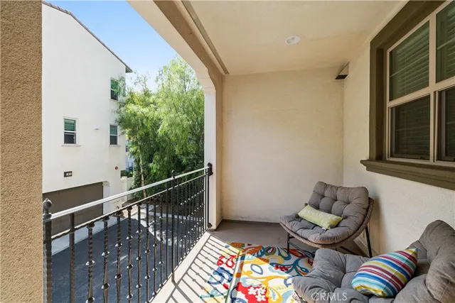 a balcony with furniture and potted plants