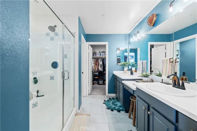 a spacious bathroom with a shower sink and mirror