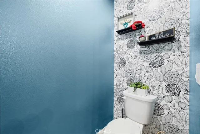 a white toilet sitting next to a bathroom sink