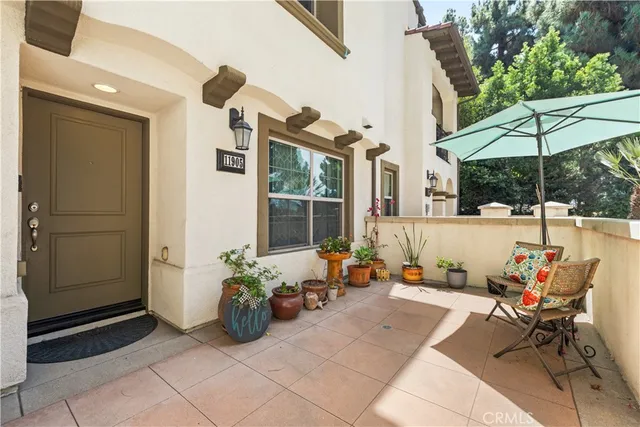 a view of a patio with table and chairs under an umbrella