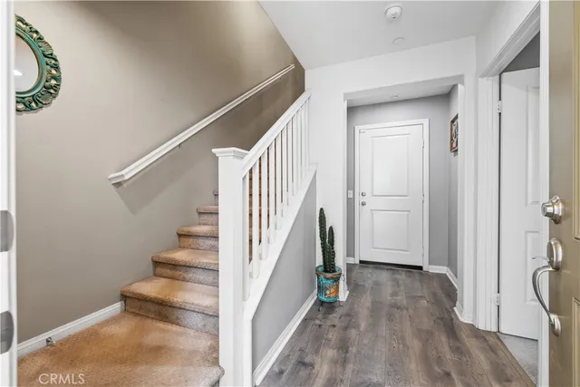 a view of entryway and hall with wooden floor