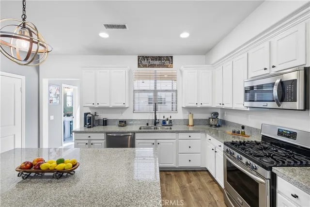 a kitchen with a sink a stove and cabinets