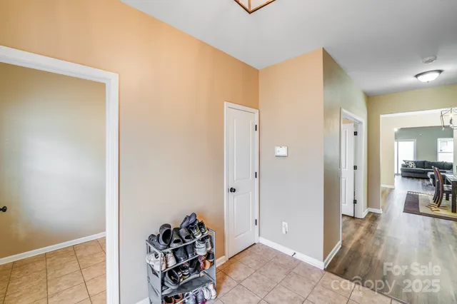 a view of a hallway with bathroom and wooden floor