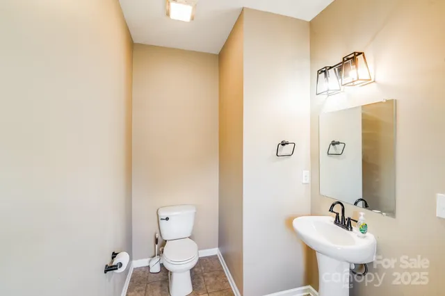 a bathroom with a sink mirror and toilet