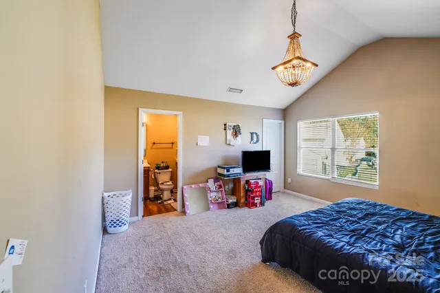 a bedroom with a bed dresser and a window